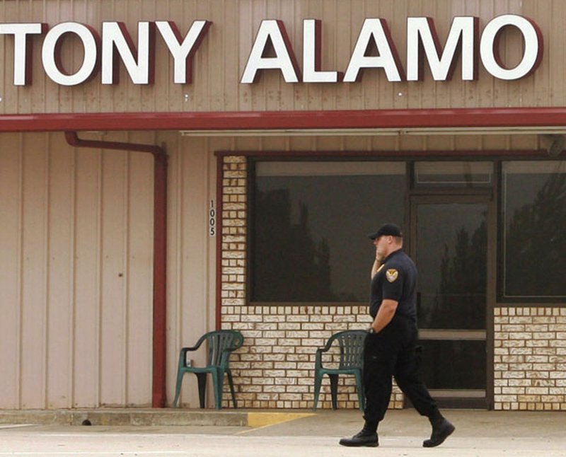In this Sept. 21, 2008 file photo, a man patrols in front of the Tony Alamo Christian Church in Fouke.