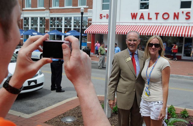 Tina Bryan, a Walmart associate from Tampa, Fla., has her photograph taken Thursday, June 2, 2011, with Bentonville Mayor Bob McCaslin in downtown Bentonville. McCaslin greeted Walmart shareholders as they visited the Walmart Visitor Center on Thursday morning.