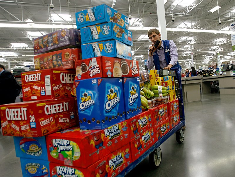  
Andrew Walker pushes a cart of merchandise across the floor at Sam's Club in Bentonville on Thursday, June 2, 2011.