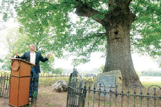 State Rep. John Catlett, D-Rover, speaks at the unveiling of a new marker for the White Oak Champion Tree on Front Street in Dardanelle. The marker is one of three that will be placed in Dardanelle. The Champion Eastern Cottonwood and Persimmon will also get new markers.