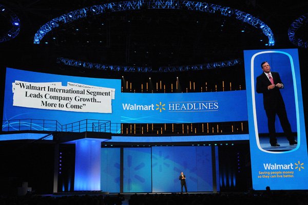 Charles Holley, Walmart chief financial officer, speaks during last year’s shareholders meeting at Bud Walton Arena in Fayetteville. The annual meeting has grown from an employee picnic to a weeklong, celebrity-studded extravaganza. Walmart will hold its annual shareholders meeting at 7 a.m. Friday.