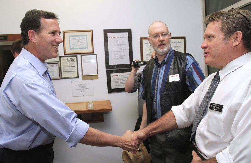 FILE - In this May 31, 2011, file photo former Pennsylvania Sen. Rick Santorum, left, shakes hands with New Hampshire state Rep. Thomas Howard before touring Rugar Firearms in Newport, N.H. Santorum is set to formally announce on Monday, June 6, 2011, he is seeking the Republican party's presidential nomination.