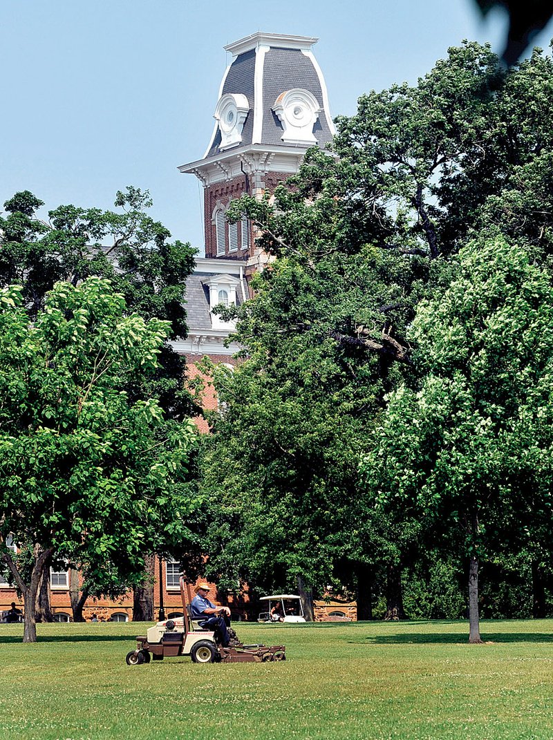 University of Arkansas officials want a temporary road across the Old Main lawn, shown here, to give construction vehicles access to projects at Ozark and Vol Walker halls.