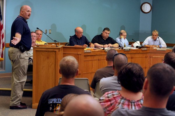 Dean Bitner, left, with the Springdale Firefighters local union, addresses members of the Springdale City Council Finance Committee meeting Monday on the Mayor’s plan to give full-time city employees a $600 bonus for 2011. Several members of the police and fire departments attended the meeting. Last Monday, the committee recommended the bonus pass when it comes to the Council today. Spokesmen for the two departments gave their thoughts on the bonus to the Council.