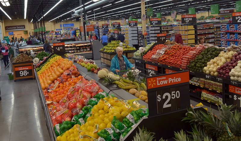   Shoppers browse through the produce department at the enterence to the new Walmart Market on 3475 W Black Forest Drive in Fayetteville.
