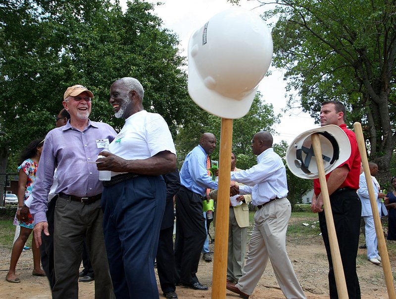 Gerald Cound (left) congratulates the Rev. William Robinson, executive director of Better Community Development, after Friday’s groundbreaking of the Empowerment Center in Little Rock. 