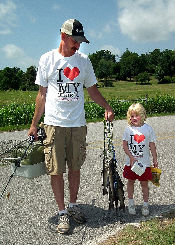Kayla Philpott, 4, and her dad, David Philpott, took their catch back to weigh in. Kayla was the overall winner for ages 1-7 with a 3.9 pound stringer.