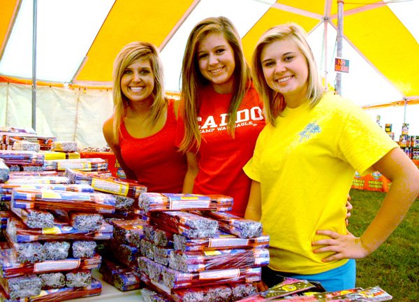 Blackhawk cheerleaders Morganne Rhine, Samantha Truesdell and Heather Patton worked the cheerleaders' fundraising fireworks stand recently. The stand, on Slack Street just east of It'll Do Road, is one of the major fundraising projects for the cheerleaders.