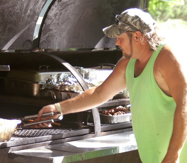 Tim Richardson barbecues chicken in the park for those attending the annual Springtown event on Saturday.
