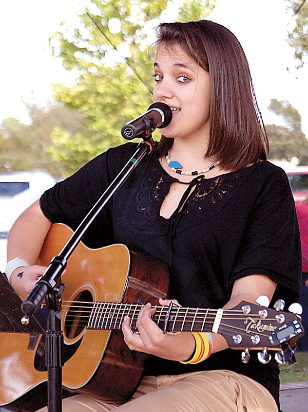 Meagan White plays on the stage in Gentry at a Fall Festival.