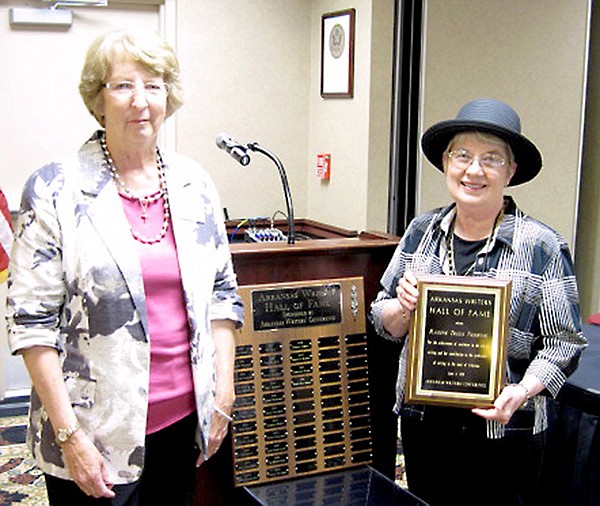 Gravette author, Radine Trees Nehring, shown on the right, accepted a plaque honoring her induction into the Arkansas Writers' Hall of Fame. Making the presentation was author and writing teacher Marilyn Collins.