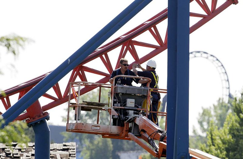  Workers inspect The Ride of Steel roller coaster at Darien Lake Theme Park Resort in Darien, N.Y., Saturday, July 9, 2011.  Sgt. James Hackemer, a U.S. Army veteran who lost his legs while deployed in Iraq was thrown from the 200-foot-tall roller coaster at the upstate theme park on Friday, July 8, 2011 and was killed.  Hackemer, 29, was ejected from the Ride of Steel roller coaster at about 5:30 p.m., the Genesee County sheriff's office said.   