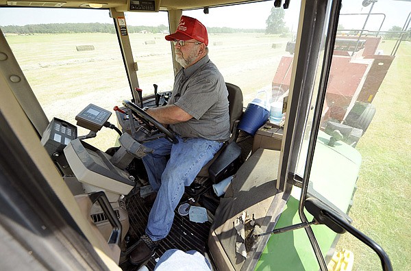 Ozzie Rodgers bales hay July 7 near Maysville. Weather has impacted hay production in the area.
