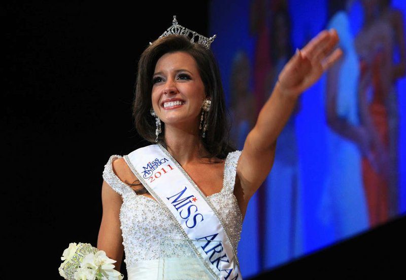 Kristin Glover waves to the crowd after being crowned Miss Arkansas 2011 by last year's winner Alyse Eady during the Miss Arkansas Pageant Saturday night in Hot Springs.