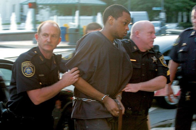 Abdulhakim Muhammad is rushed into the Pulaski County Courthouse on Monday for the first day of jury selection in his capital-murder trial. 