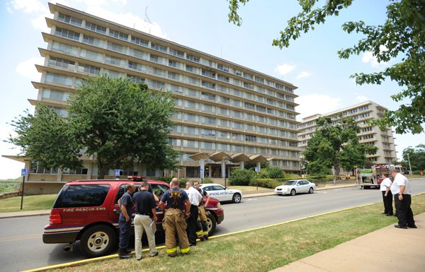 Fayetteville Fire Department, Central Emergency Medical Service and University of Arkansas personnel gather Tuesday at the east entrance of the University of Arkansas’ Yocum Hall in Fayetteville after a report that a white power had been found on the 4th floor of the building. The powder was later discovered to be foot powder left as a prank by a high school band camp participant.