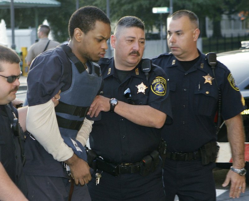 Abdulhakim Muhammad, second from left, is escorted to the Pulaski County Courthouse in Little Rock, Ark., where his trial for the shooting death of an Army recruiter and wounding of another continues Thursday, July 21, 2011.