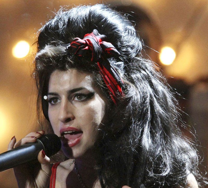 In this Feb. 20, 2008, file photo, Amy Winehouse performs at the Brit Awards 2008 in London.