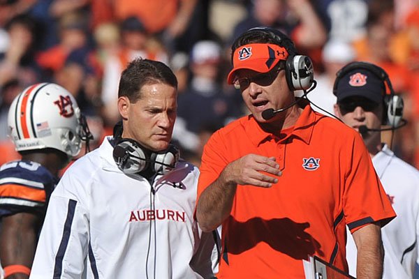 Auburn offensive coordinator and former Springdale High School head coach Gus Malzahn (right) is expected to be named the head coach at Arkansas State on Wednesday afternoon. Sources confirmed he will be hired to replace Hugh Freeze, who left to take the same post at Ole Miss.