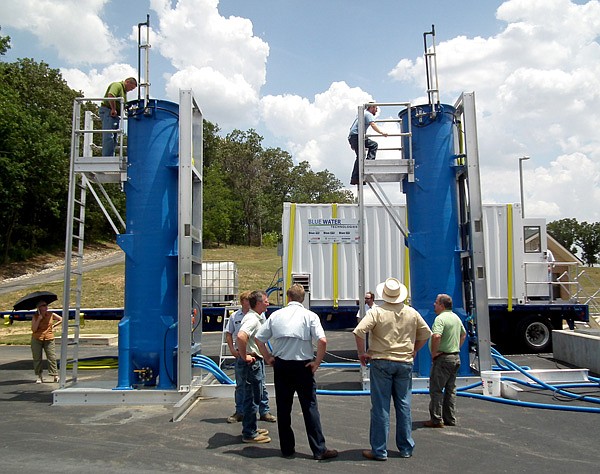 More than 30 people from the Arkansas Department of Environmental Quality, engineering firms and local municipalities toured the pilot Blue PRO filter set up at the Decatur Wastewater Treatment Plant. Many climbed the 18-foot-tall tanks for a peek inside and also walked through the trailer to view how the controls and monitors worked.
