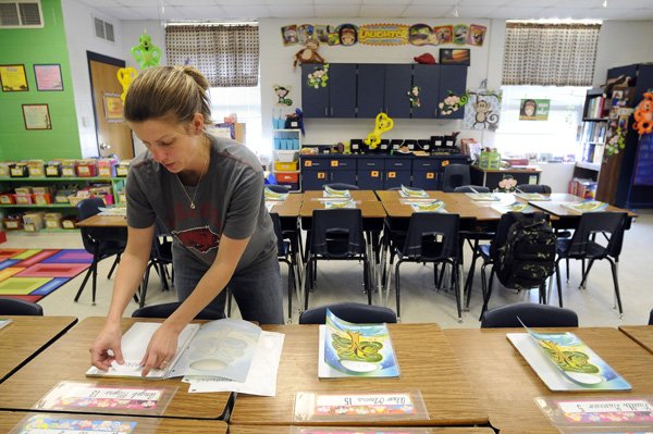  Third-grade teacher Della Hutcheson prepares daily planners for her incoming students Friday, July 29, 2011, while getting her classroom ready for the first day of school at Eastside Elementary School in Rogers. Monday is the first day back to school for Eastside Elementary, which is the only "year-round" school in the Rogers School District. This will be Hutcheson's 10th year teaching at Eastside Elementary.
