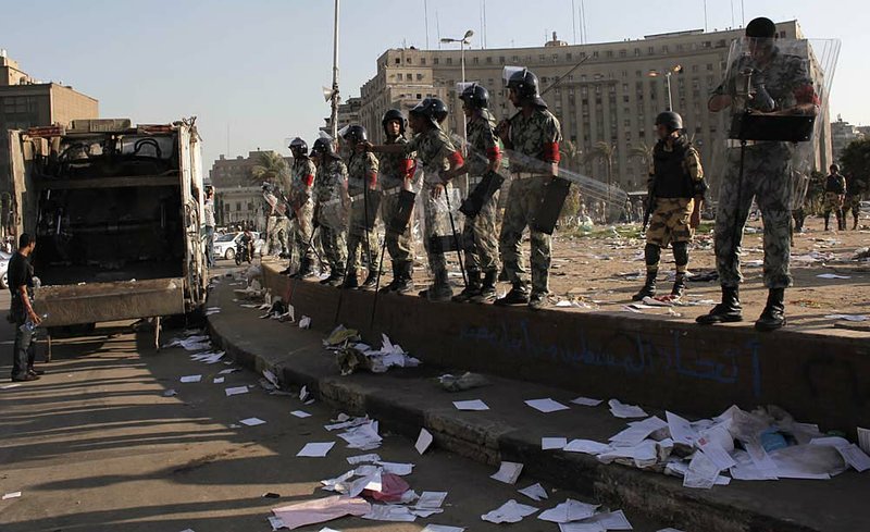  Soldiers stand guard Monday after tearing down protesters’ encampment in Cairo’s Tahrir Square. 