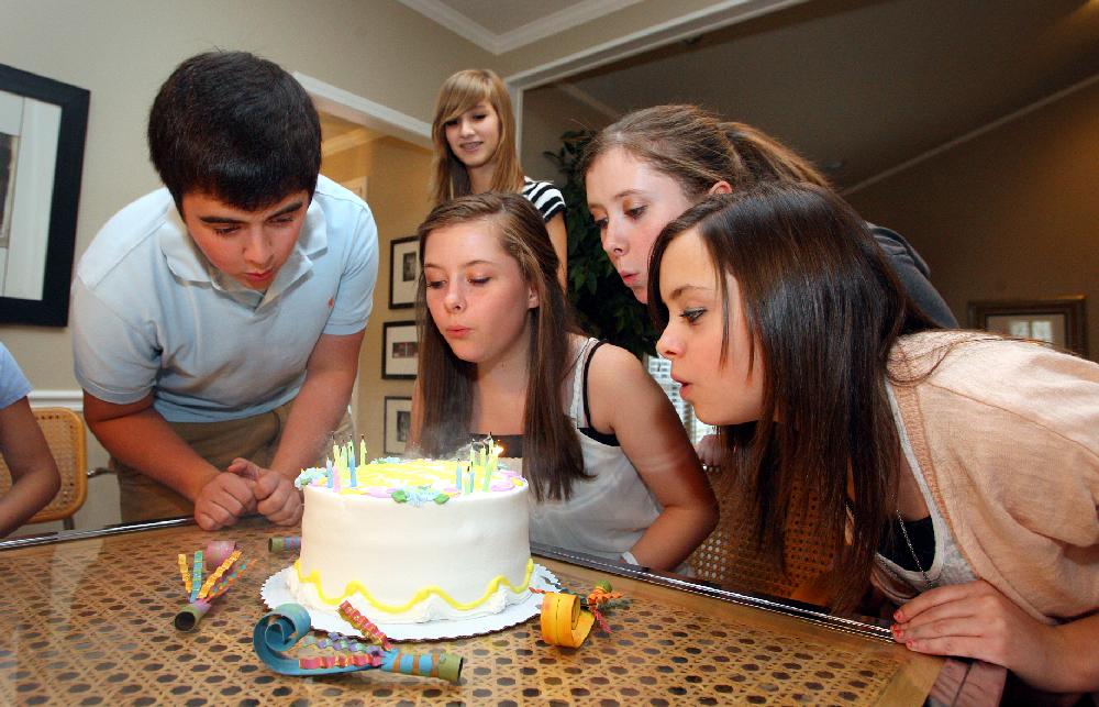 7/31/11
Arkansas Democrat-Gazette/STEPHEN B. THORNTON
Carter quadruplets from left, Michael, Leslie, Katherine, and Ashley blow out candles on their 16th birthday cake at the home of their grandparents Jim and Patti Dailey  Sunday afternoon. In background at top is their cousin Mary Dailey, 15.