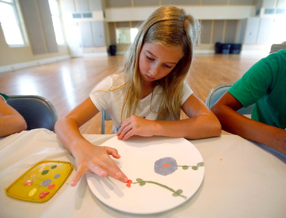 Arkansas Democrat-Gazette/JASON IVESTER --08/02/11--
Brooklyn Lykins (cq), 9, of Gravette paints a design on her plate during Ceramics Camp inside the American Legion Community Hall in Siloam Springs on Tuesday, August 2, 2011. The week-long camp offered through the City of Siloam Springs is led by Jackie Katsuren (cq).