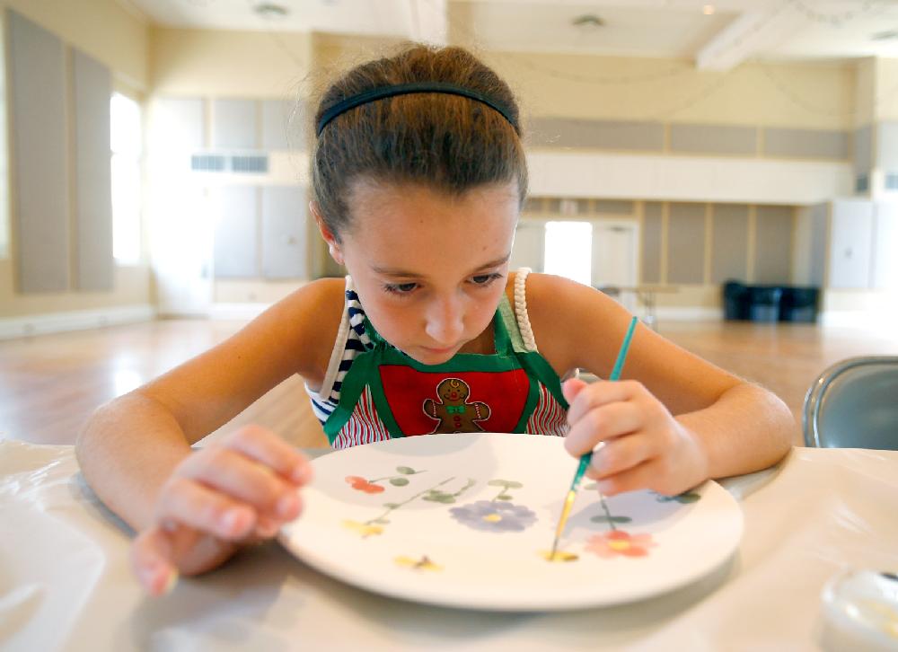 Arkansas Democrat-Gazette/JASON IVESTER --08/02/11--
Alex Sumrall (cq), 9, of Bella Vista paints a design on her plate during Ceramics Camp inside the American Legion Community Hall in Siloam Springs on Tuesday, August 2, 2011. The week-long camp offered through the City of Siloam Springs is led by Jackie Katsuren (cq).