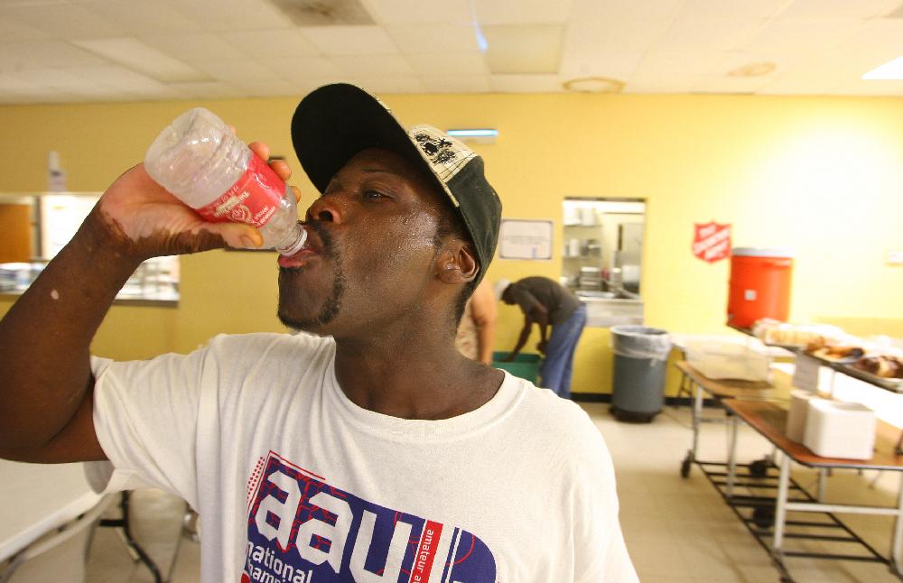 8/2/11
Arkansas Democrat-Gazette/STEPHEN B. THORNTON
Sweat beads on his face as Aljabbar Salam gulps down his first bottle of cold water upon enter the cooling station at the Salvation Army at 1111 W. Markham Street Tuesday afternoon in Little Rock. Salam says he has been living on the streets after moving to Little Rock from Magnolia to look for work. The Salvation Army opens it's doors as a cooling center from 1-4pm everyday the heat index rises above 100 degrees.