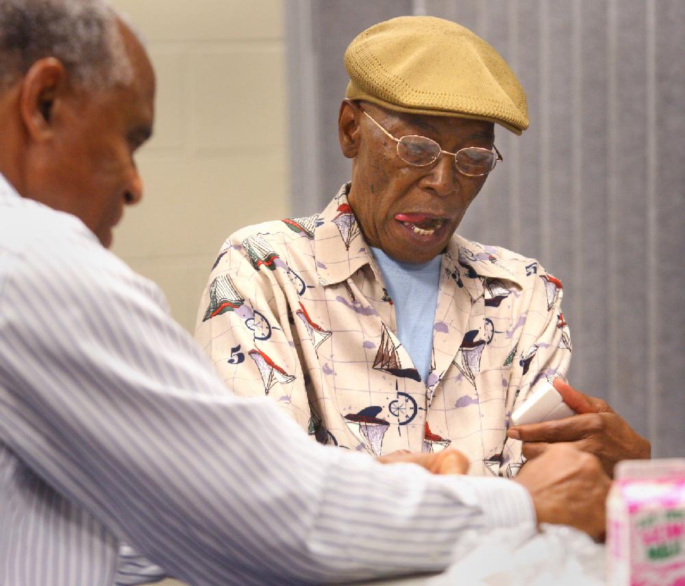 8/2/11
Arkansas Democrat-Gazette/STEPHEN B. THORNTON
Lawrence Riggins, right, concentrates on his tiles as he plays dominoes with Porter Mitchem, left, and other friends Tuesday morning at the Dunbar Community Center in Little Rock.  (MITCHEM IS CQ)