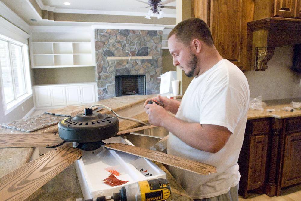Arkansas Democrat-Gazette/KAREN E. SEGRAVE
8/2/11

Zach Hannahs with Kinsley Electric prepares to install his eight ceiling fan of the day in a new home in the final stages of construction located at #3 Bluestem in Little Rock on Tuesday.  New home construction is on the decline in Arkansas.