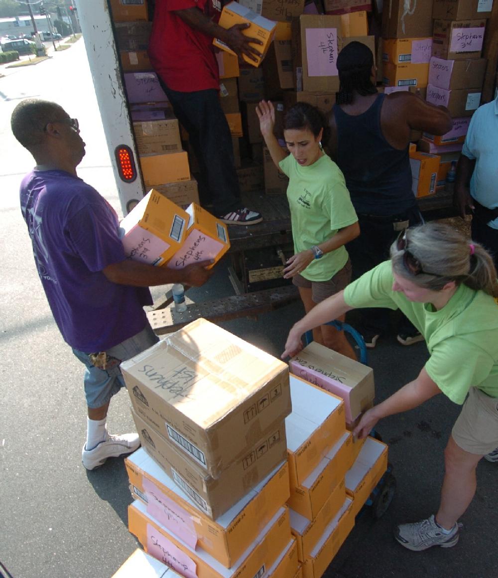 Arkansas Democrat-Gazette/STEVE KEESEE 7/28/11 Volunteers, Kay Payne (center) and Ashley Zimmer from the Junior League of Little Rock help Little Rock School District employees, Kem Austin (left) load boxed school supplies into one of three trucks used Thursday to deliver the donated items for students to six district elementary schools. The JLLR program called Stuff the Bus began five years ago with the goal of adding one LRSD elementary a year.