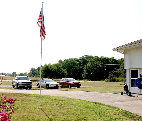 A new building for Gravette's Care and Share operation will soon be located on ground immediately behind the vehicles in this photo. Construction is expected to begin within the next few weeks.