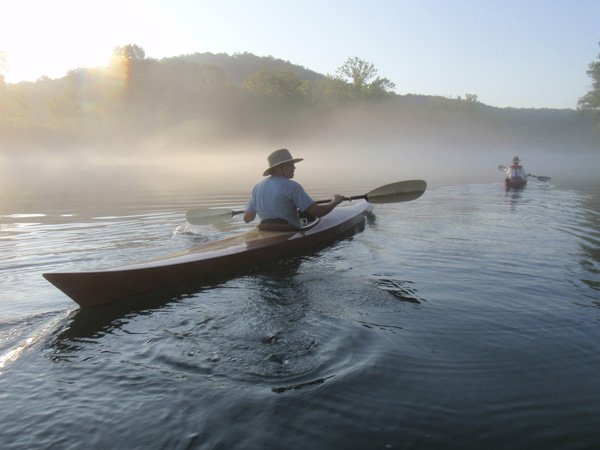 Doug Powell, featured in the story above, glides up the White River last Thursday morning. The cool river is an oasis for paddling, fishing or wading during summer.