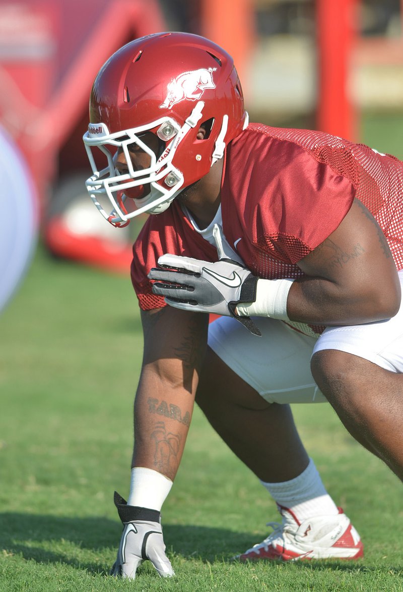   University of Arkansas fullback Kierno Small runs drills during the Razorbacks practice Friday evening in Fayetteville.