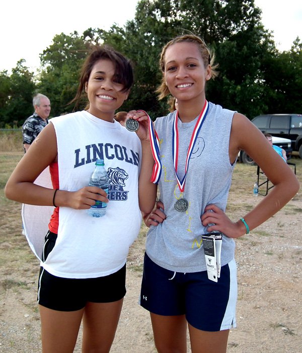 Sara and Mara Harris displayed their medals after winning second and first place, respectively, in the 2K Race.

