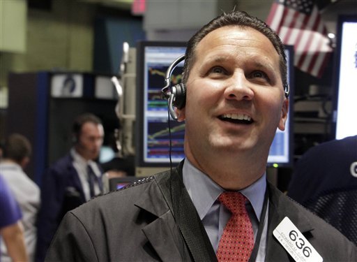 Trader Edward Curran smiles as he works on the floor of the New York Stock Exchange on Thursday, Aug. 11, 2011.