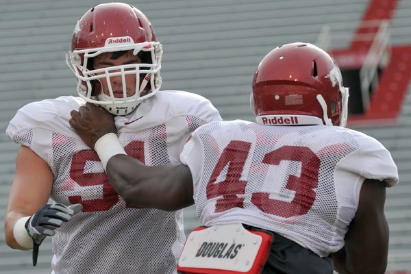 In this photo taken Sept. 3, 2011, Arkansas defensive end Jake Bequette  adjusts his helmet during the NCAA college football game against Missouri  State in Fayetteville, Ark. Arkansas expects a step up