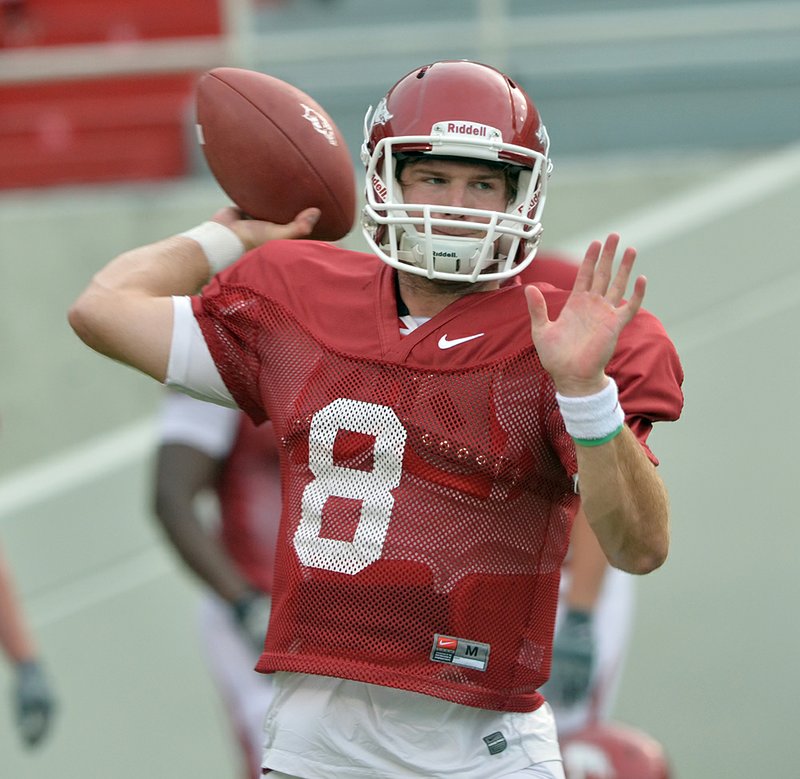   University of Arkansas quarterback Tyler Wilson runs drills during practice Thursday afternoon at Razorback Stadium in Fayetteville.