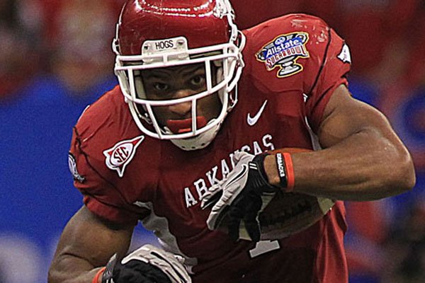  Knile Davis runs down the field during the second quarter of the Sugar Bowl against Ohio State on Jan. 4, 2011. Davis will return to Arkansas next season.