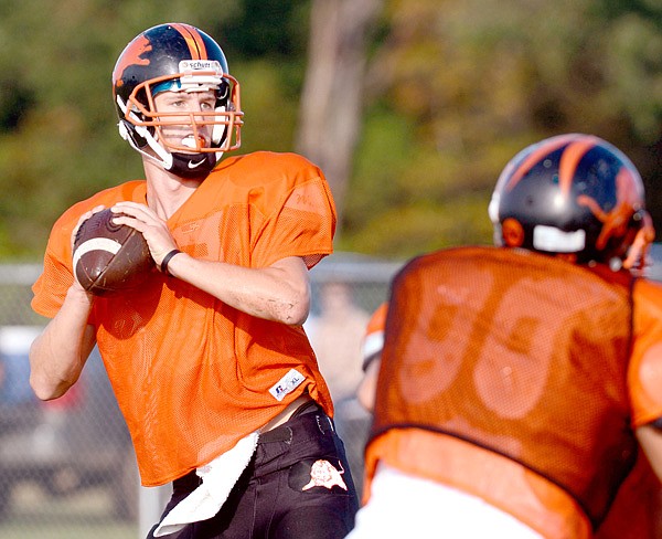Clayton Alexander drops back to pass during the Gravette Lions' scrimmage on Saturday.