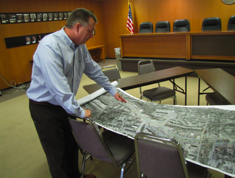 Glenn Bolick, a spokesman with the Arkansas Department of Highways and Transportation, points to a preliminary plan for adding a fifth lane to Cantrell Road between Mississippi Avenue and Perryville Road.