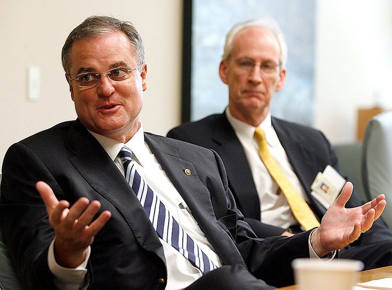 Austin Gaines (right), an executive with the Sisters of Mercy Health System, listens as U.S. Sen. Mark Pryor, D-Ark., speaks during a meeting Tuesday at Mercy Medical Center in Rogers.