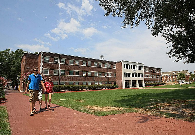 FILE - Todd Burns (left), R.J. Durham (middle) and Kaitlyn Ballard walk along a freshly stained sidewalk near Arkansas Hall on the University of Central Arkansas campus in Conway in this Aug. 23, 2011 file photo. 
