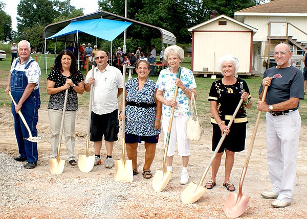 Breaking ground for a new 150-by-60-foot Care and Share building in Gravette were, from the left, Keith Boldt, Brenda Yates, Bo Roberts representing his father Marion Roberts, Vicki Hearne, Virginia Todd, Sandy Bugner and Bill Bugner.
