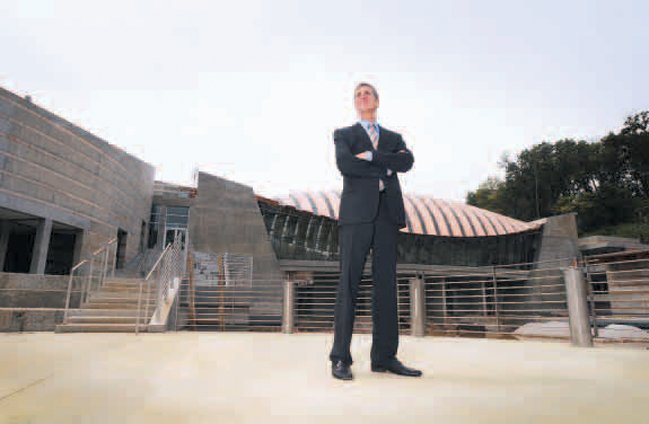 Don Bacigalupi, Crystal Bridges’ director, stands Aug. 11 in the commons area of the $100 million state-of-the-art building nestled in a forested area in Bentonville. The museum is set to open on Nov. 11 with four times the endowment of the Whitney Museum.