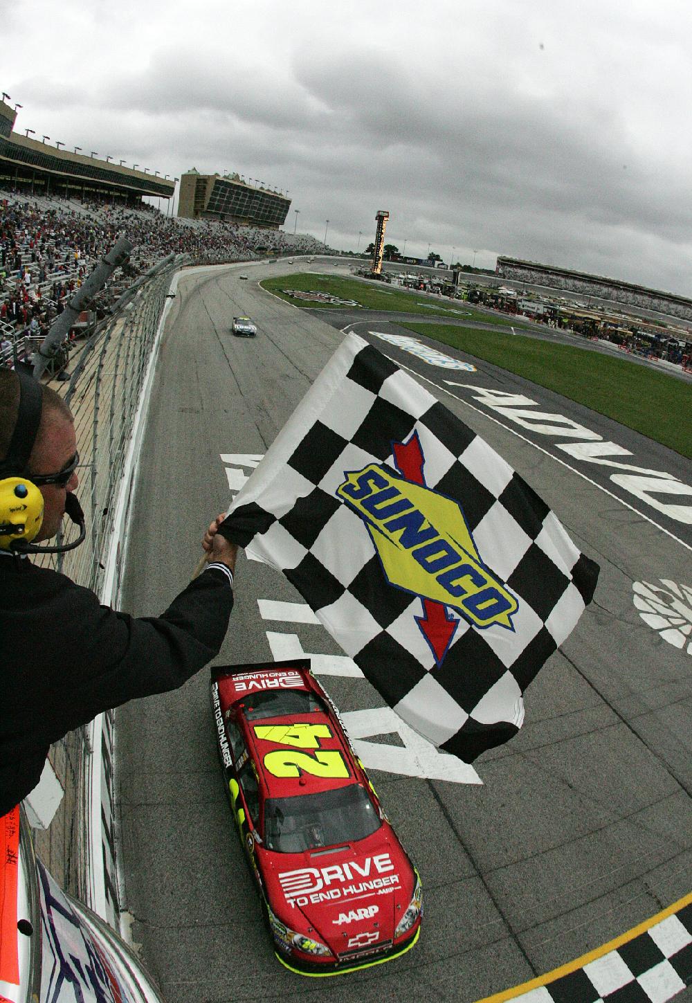 In this image provided by HPP Images, driver Jeff Gordon (24) crosses the finish line to win the NASCAR Sprint Cup AdvoCare 500 auto race, Tuesday, Sept. 6, 2011, at the Atlanta Motor Speedway, in Hampton, Ga. (AP Photo/HHP Images, Alan Marler) MANDATORY CREDIT