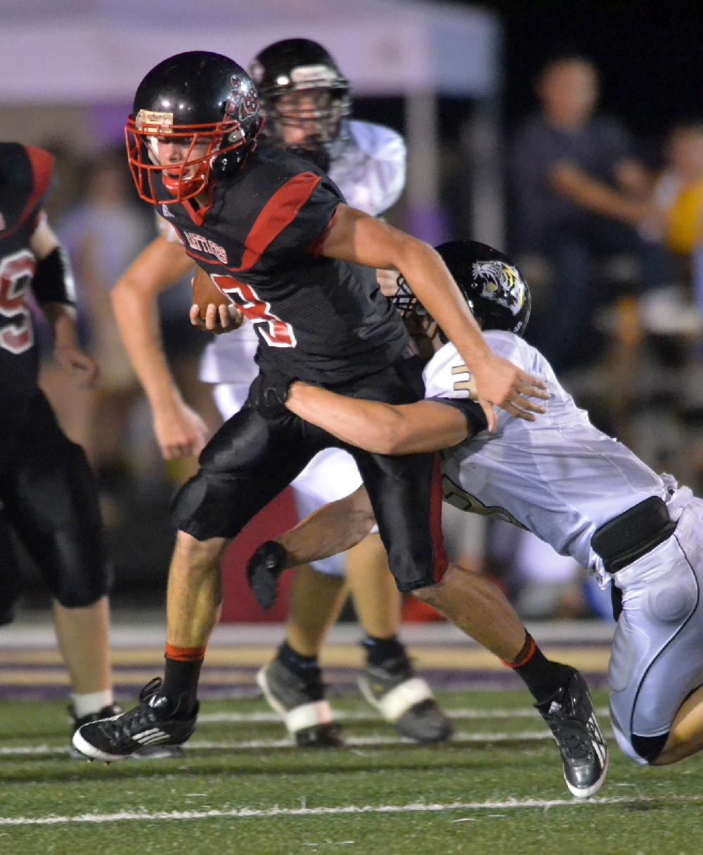 Arkansas Democrat-Gazette/MICHAEL WOODS  --08/30/11-- Magazine quarterback Ryan Chambers tries to shake West Fork defender Wil Jarnagan as he runs for a big gain in the first half of Tuesday night's game in Ozark.