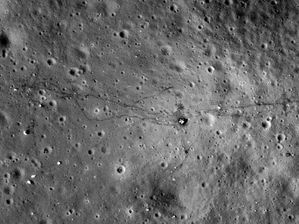 This August 2011 image made available by NASA shows paths left by walking astronauts, single lines, and lunar buggy tracks, parallel lines, from the 1972 U.S. Apollo 17 moon mission. NASA's Lunar Reconnaissance Orbiter made this and other photographs of lunar landing sites from 13 to 15 miles above the moon's surface. (AP Photo/NASA)